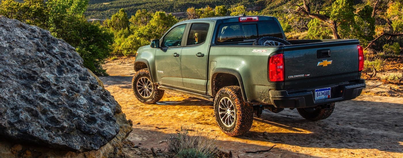 A green 2020 Chevy Colorado is shown from the rear parked while off-roading.