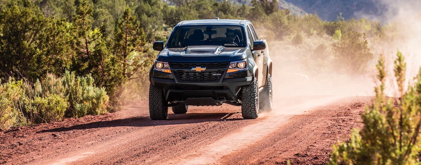 A black 2020 Chevy Colorado ZR2 is shown from the front off-roading after leaving a Certified Pre-owned Chevy truck dealer.