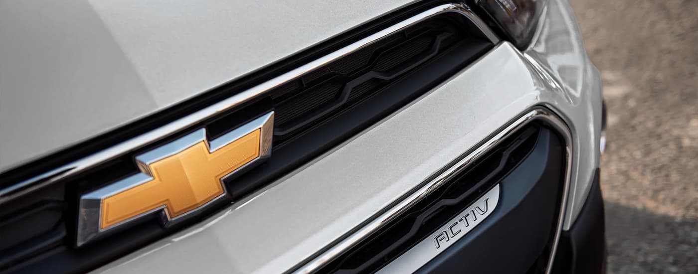 A close up shows the grille on a white 2022 Chevy Spark Activ after visiting a Miami, OK Chevy dealer.