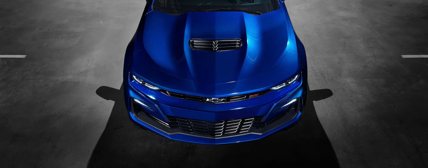 A blue 2022 Chevy Camaro SS is shown from the front parked in a parking lot.
