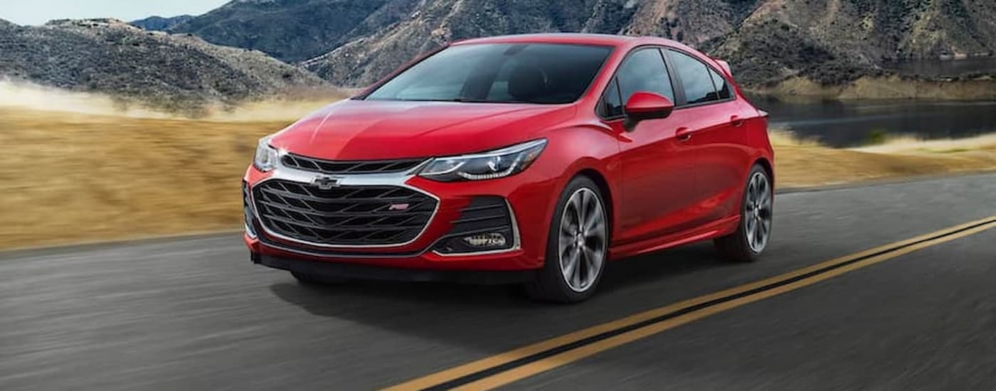 A red 2019 Chevy Cruze is shown driving on a highway after leaving an Oklahoma Chevy dealer.