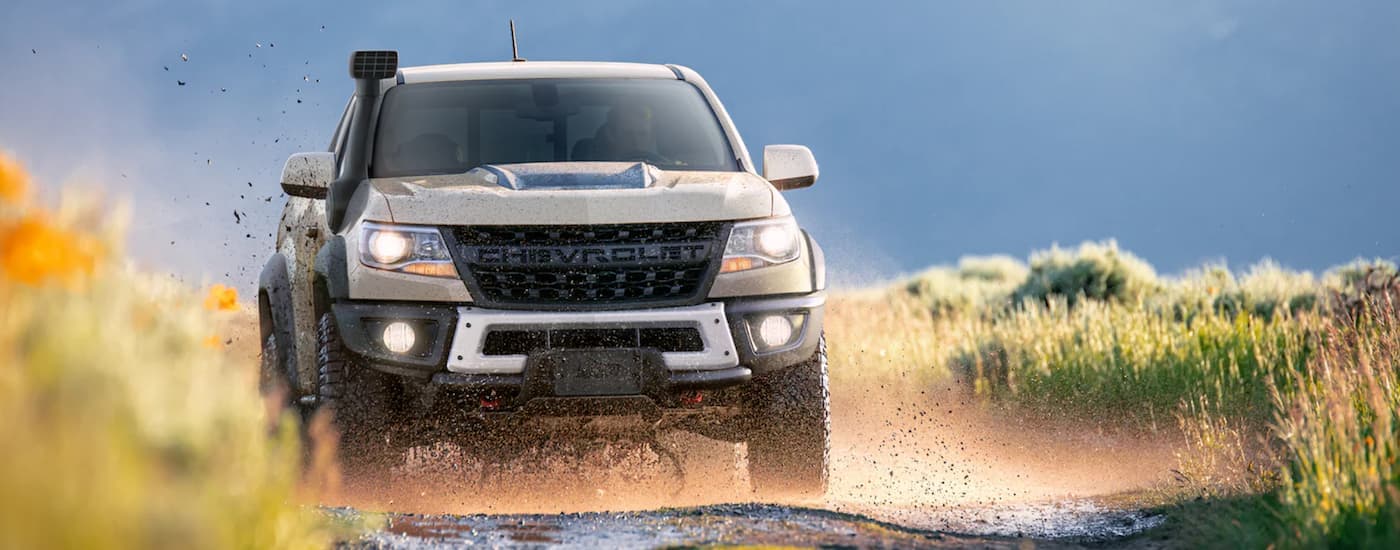 A tan 2022 Chevy Colorado ZR2 is shown from the front off-roading.
