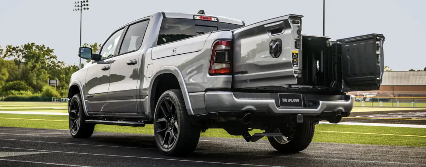 A silver 2020 Ram 1500 is shown from the rear parked on a track.