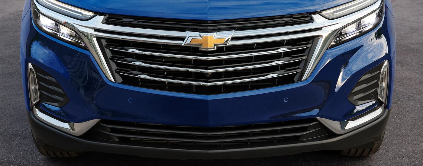 A close up of the front grille of a 2022 Chevy Equinox is shown at a Pryor, OK Chevy dealer.