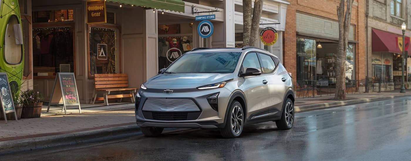 A silver 2022 Chevy Bolt EUV is shown from the front parked on a city street after searching 'trade in my car.'