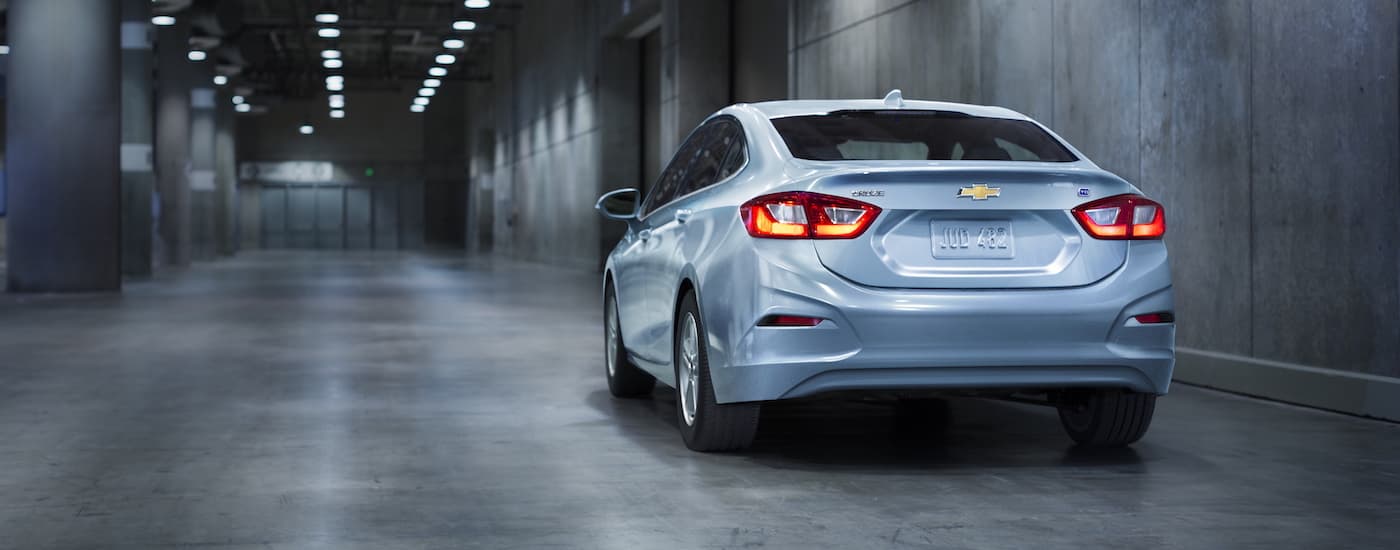 A silver 2018 Chevy Cruze is shown in a warehouse after leaving a used car lot.