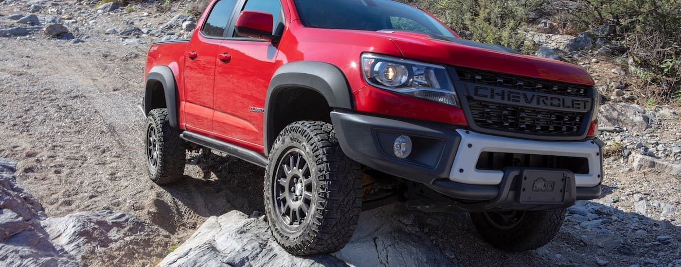 A red 2019 Chevy Colorado ZR2 Bison is shown parked on a rock.