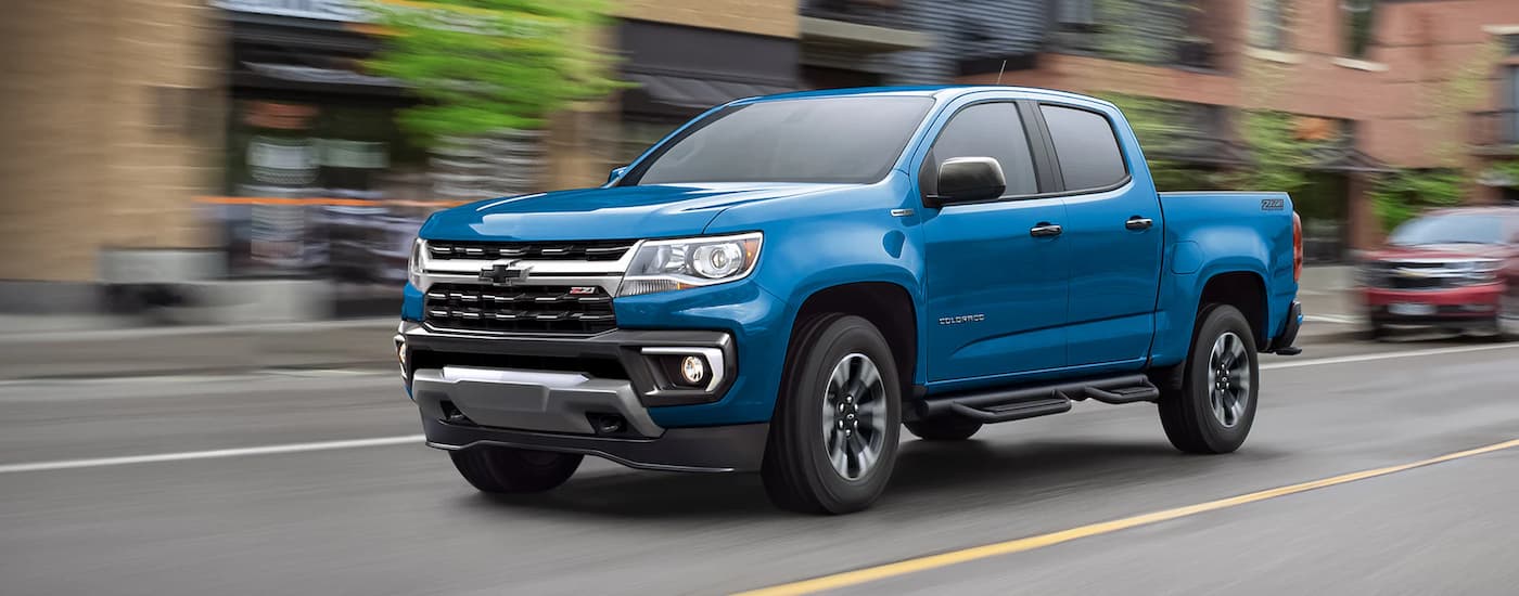 A 2022 Chevy Colorado Z71 is shown driving on a city street.
