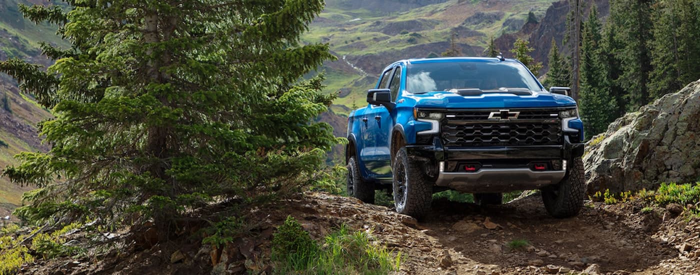 A blue 2022 Chevy Silverado 1500 is shown from the front off roading.