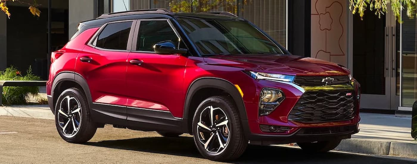 A red 2022 Chevy Trailblazer RS is shown parked on a city street at night.